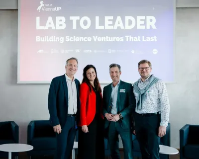 peter ertl, bernadette Kamleitner, Alexander Svejkovsky and Markus Wanko posing in front of presentation that states "Lab to Leader - Building science ventures that last"